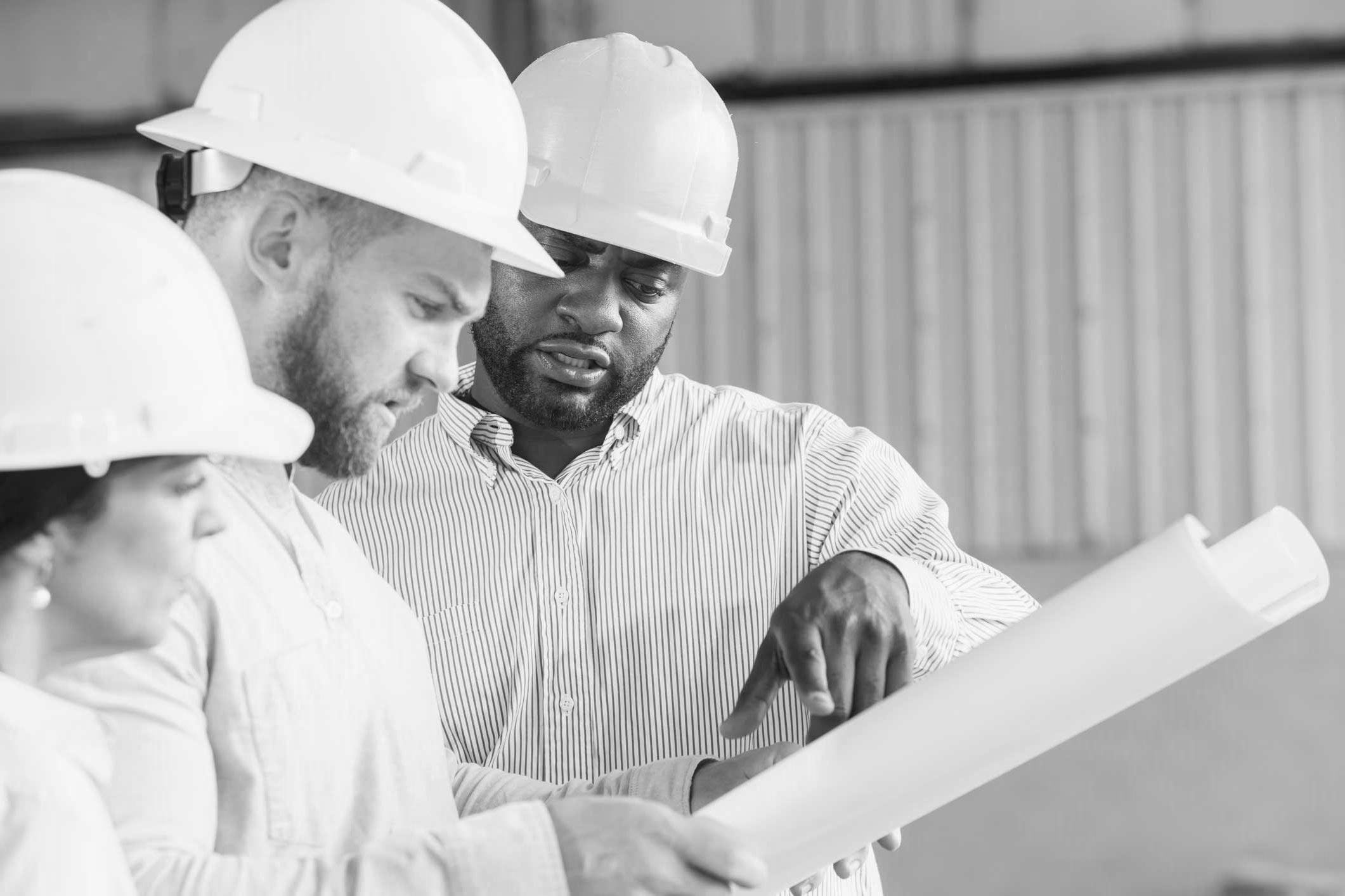 team of construction workers looking at blueprints